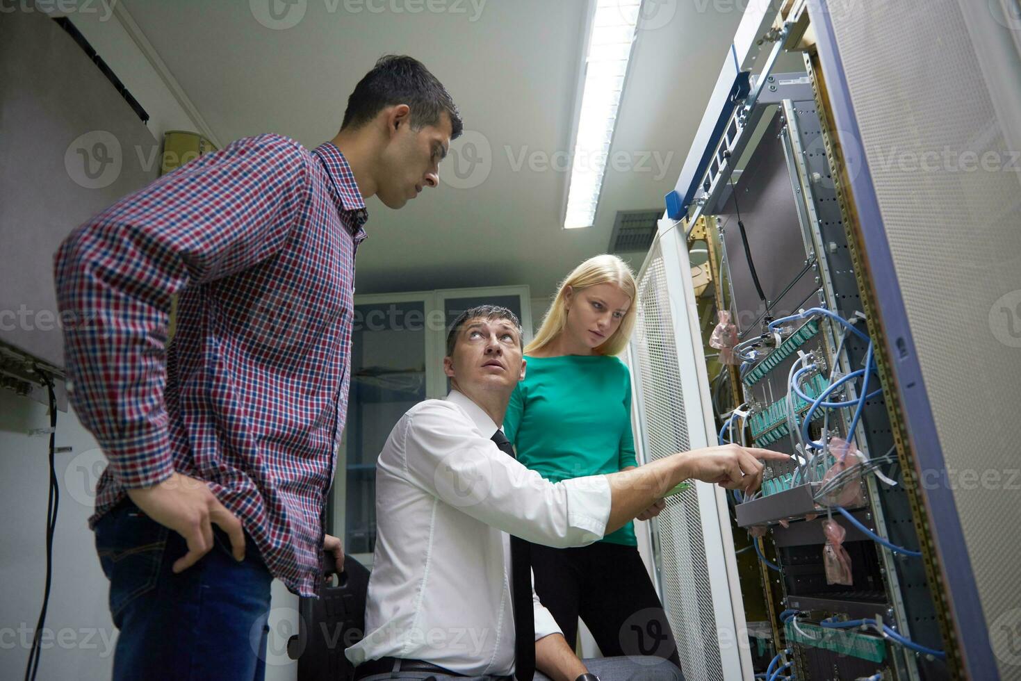 network engeneers working in network server room photo