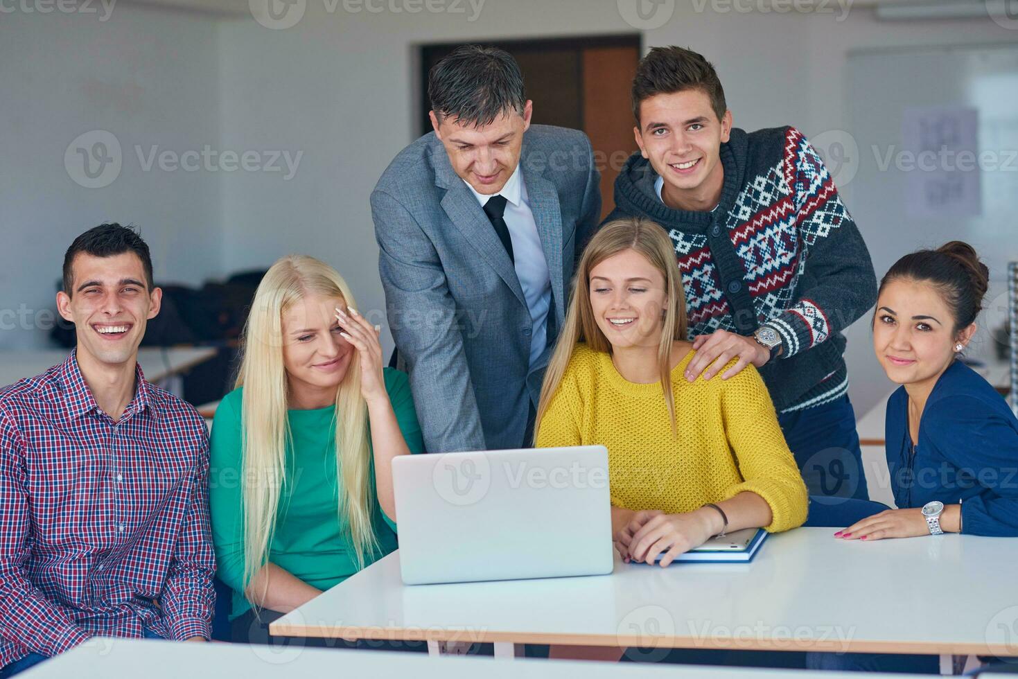 group of students getting suppport from teacher photo