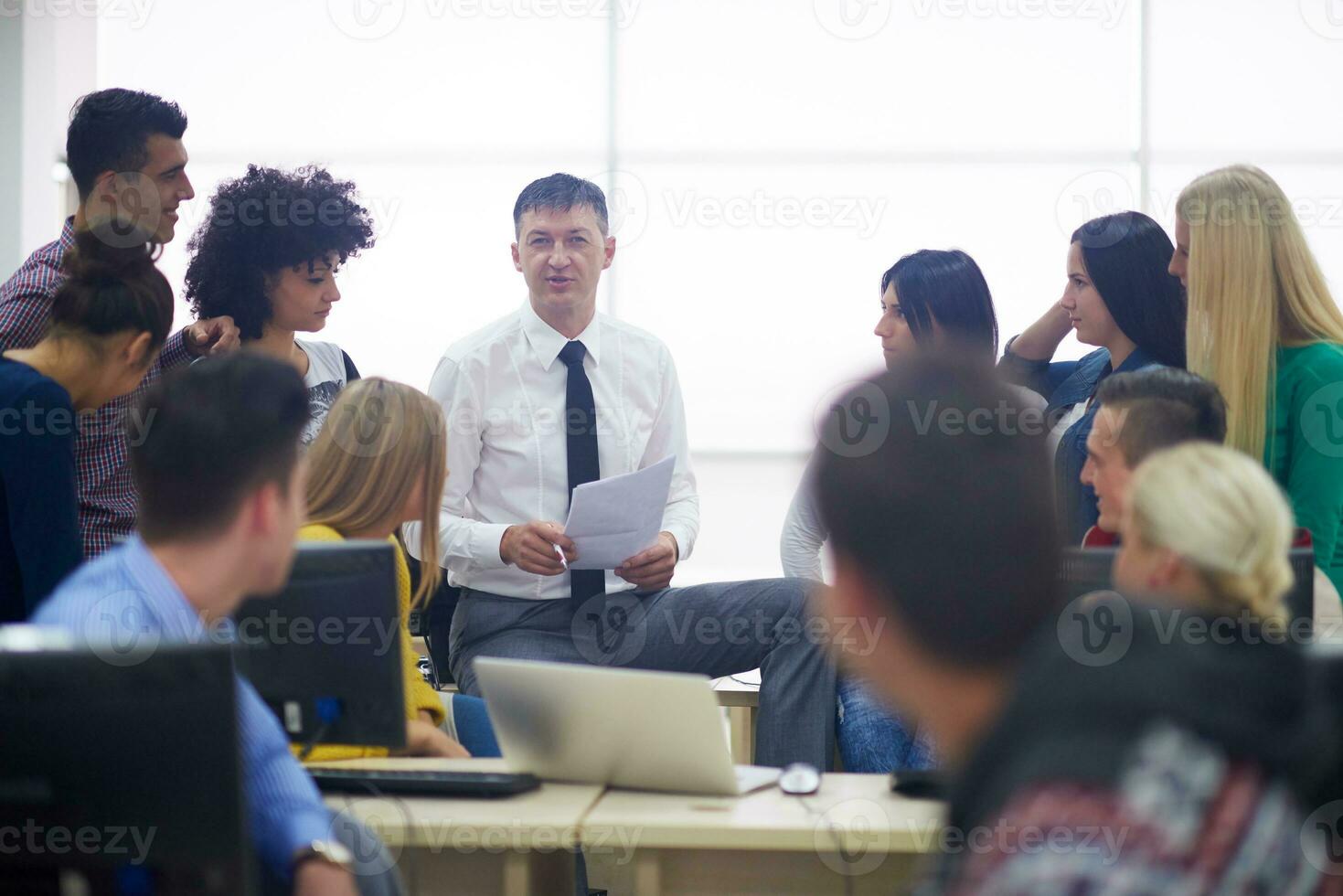 students with teacher  in computer lab classrom photo