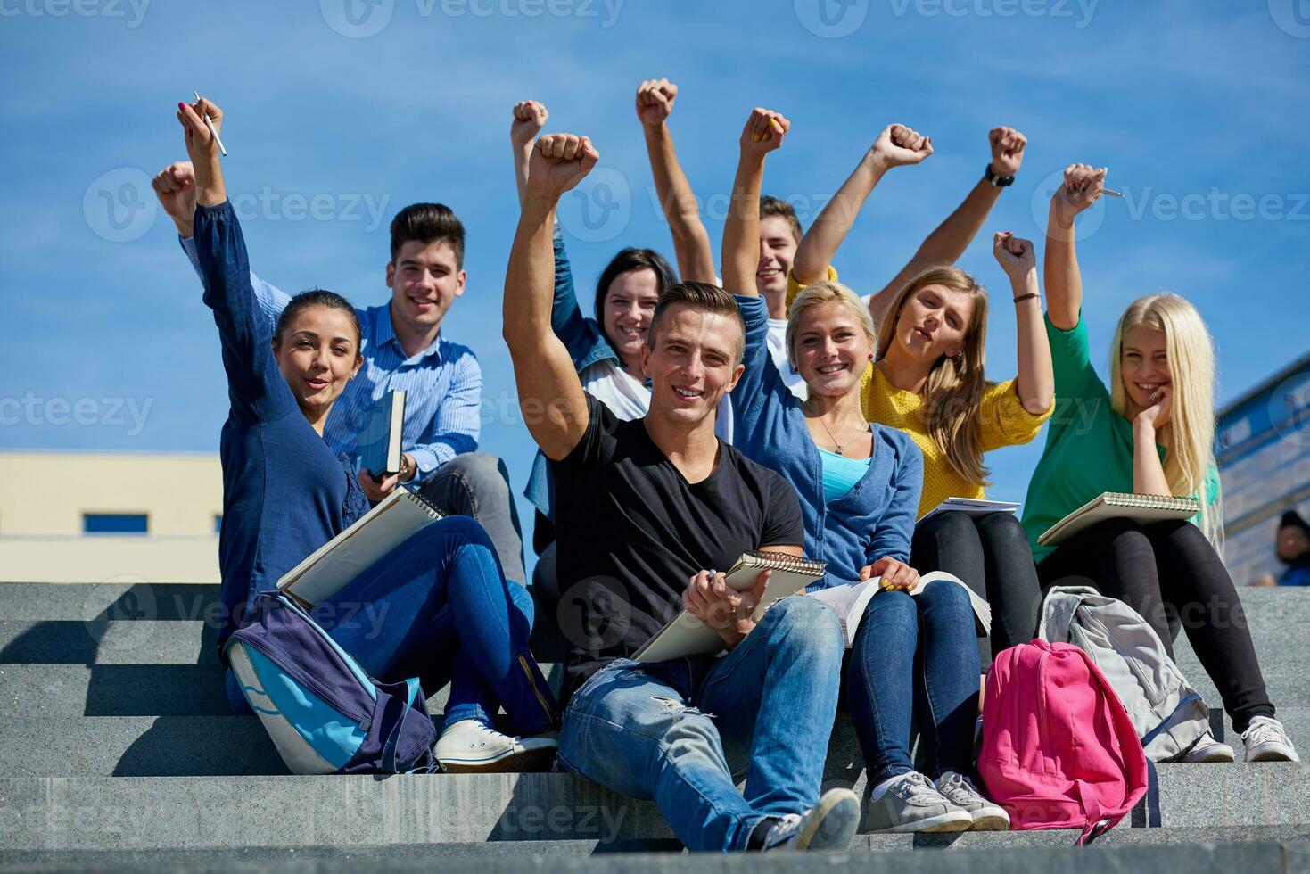 students outside sitting on steps photo