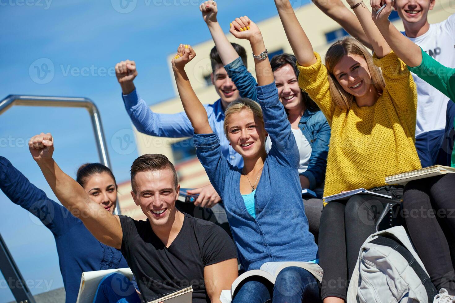 students outside sitting on steps photo