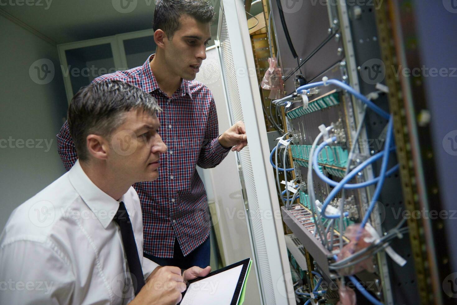 network engineers in server room photo