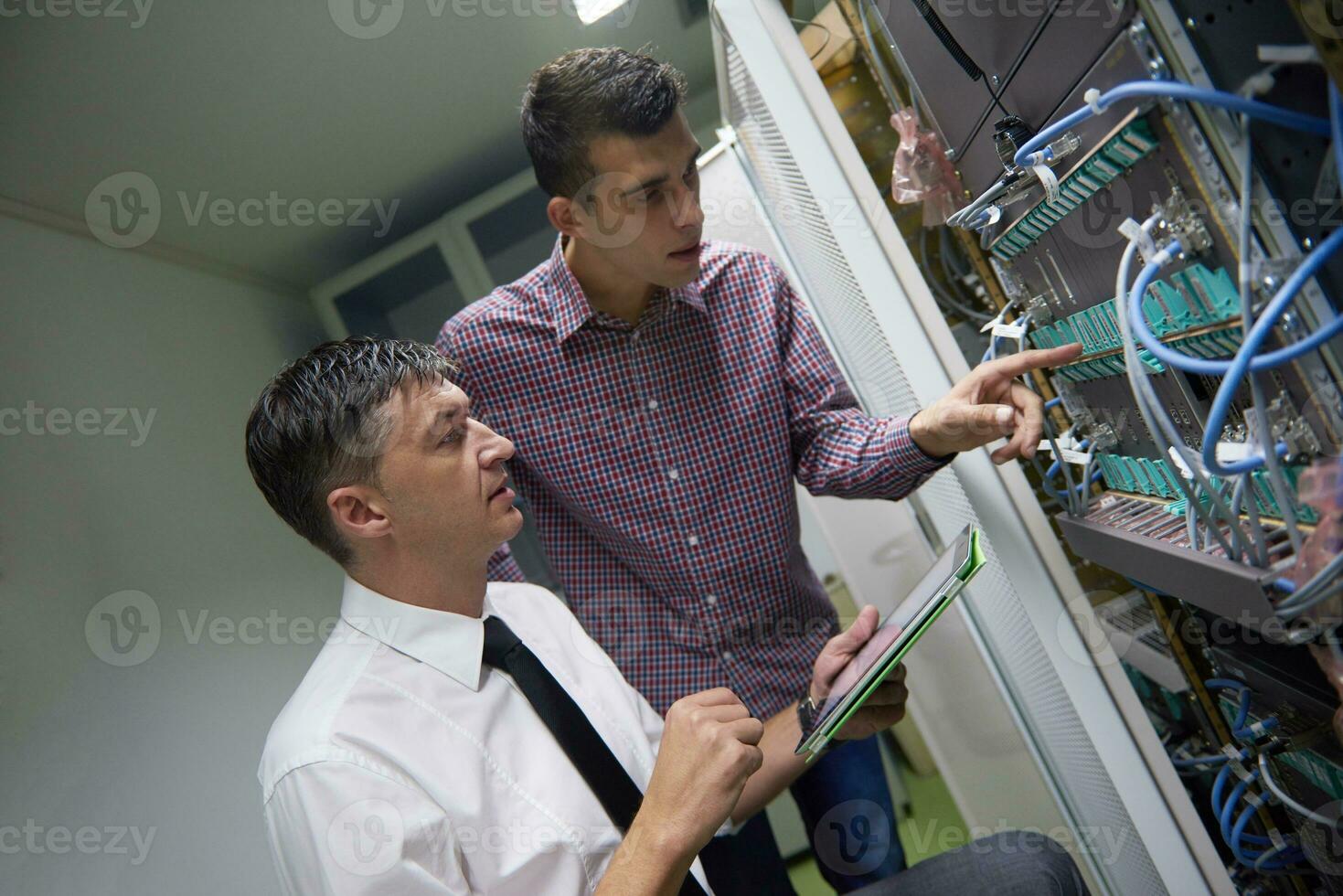 network engineers in server room photo