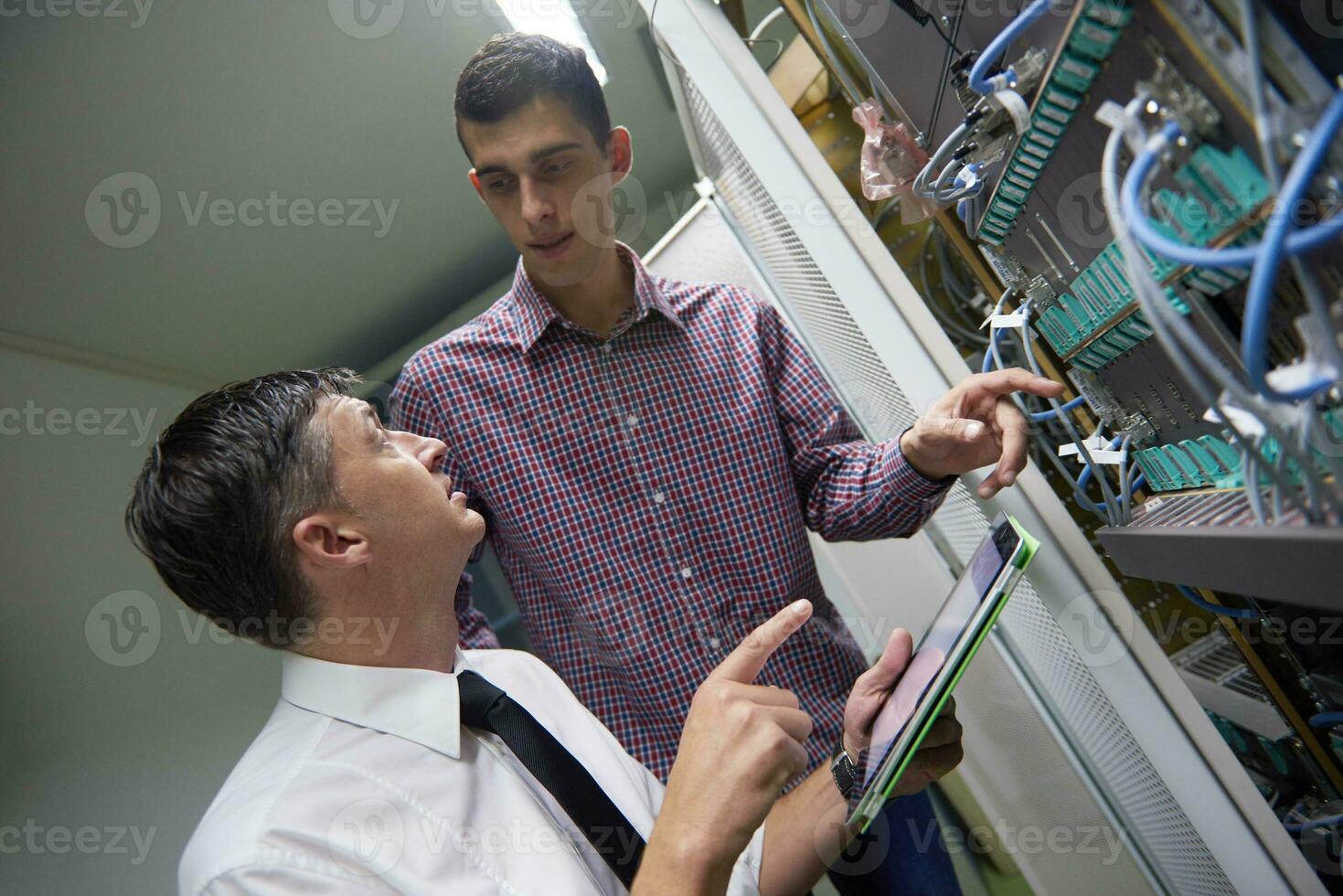 network engineers in server room photo