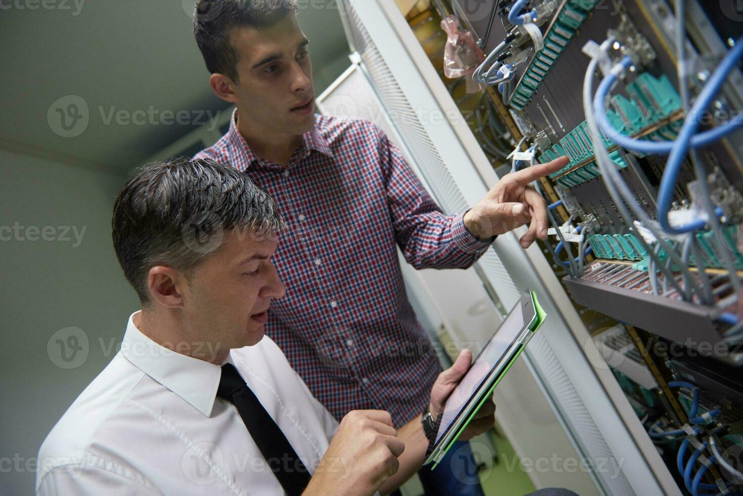 network engineers in server room photo