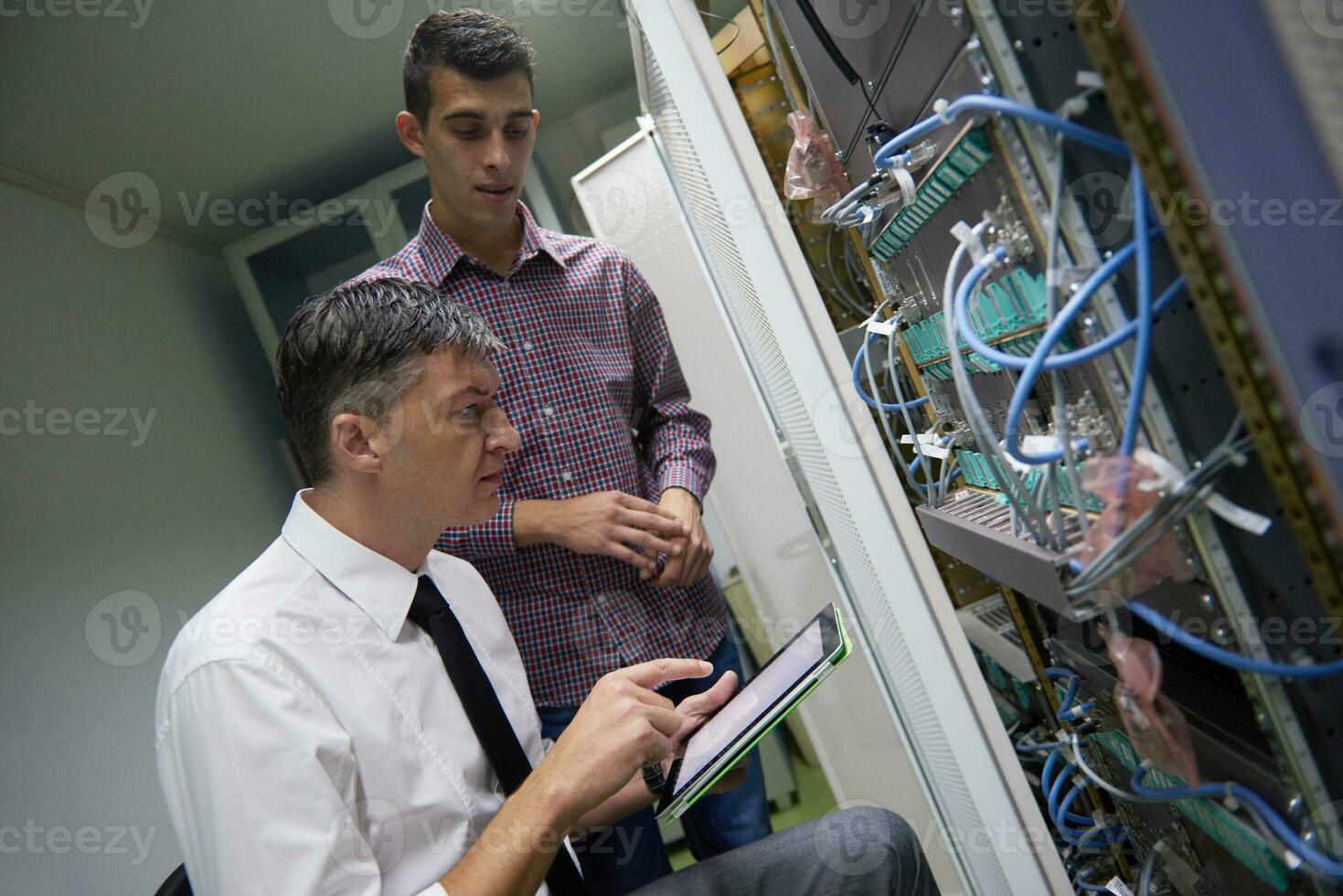 network engineers in server room photo