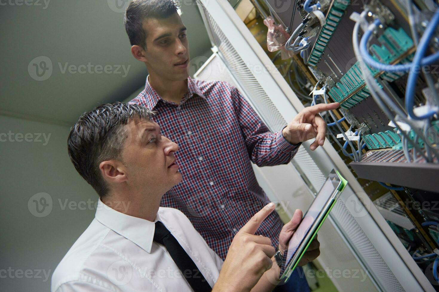 network engineers in server room photo
