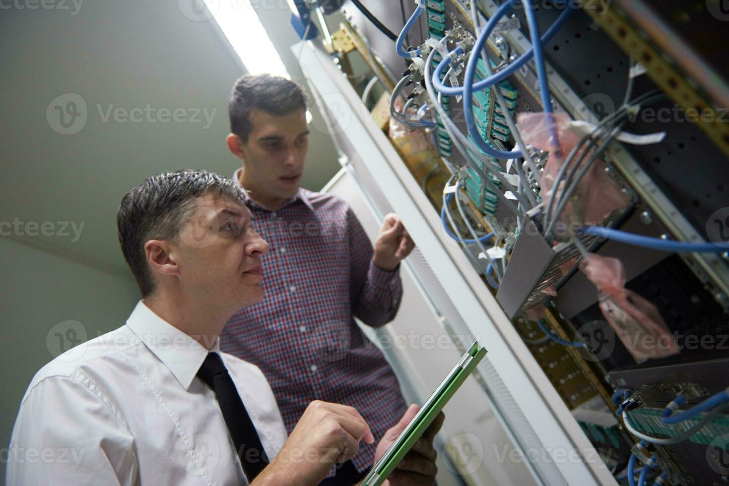 network engineers in server room photo