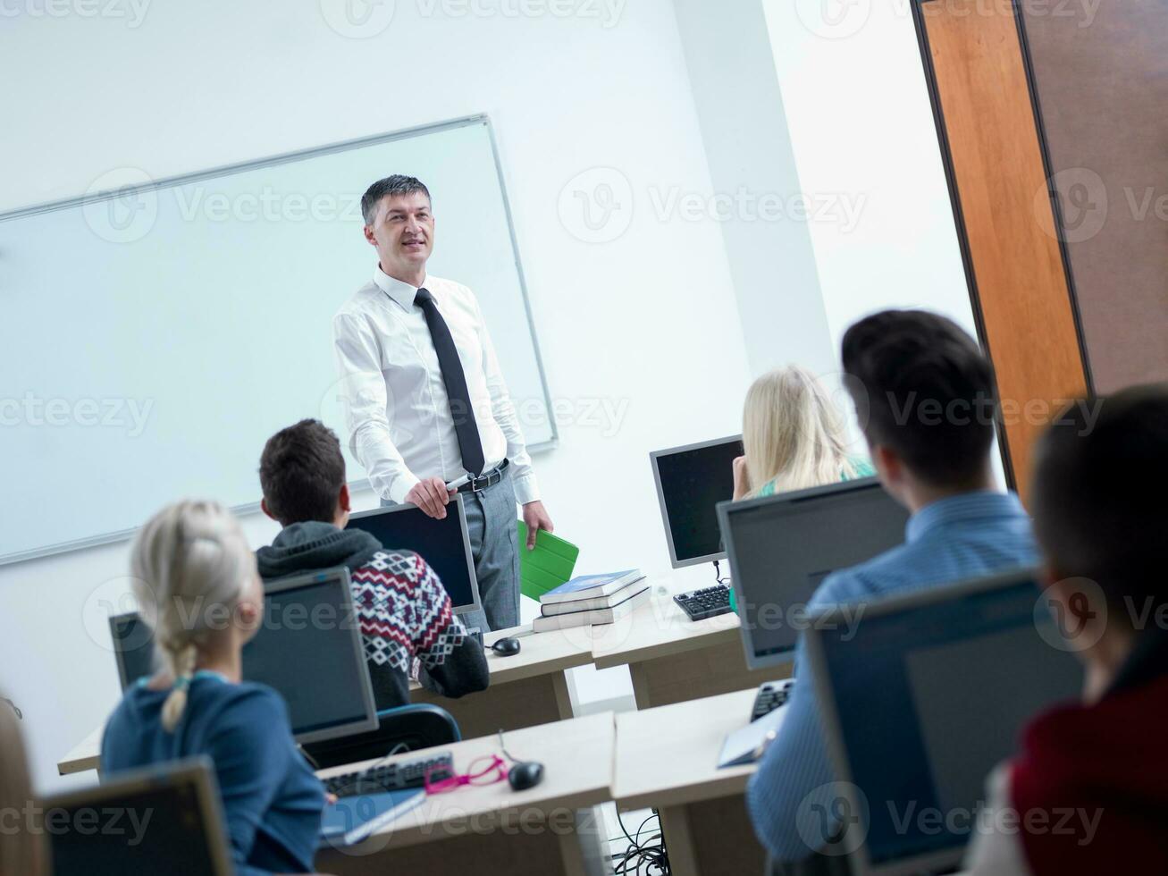 students with teacher  in computer lab classrom photo