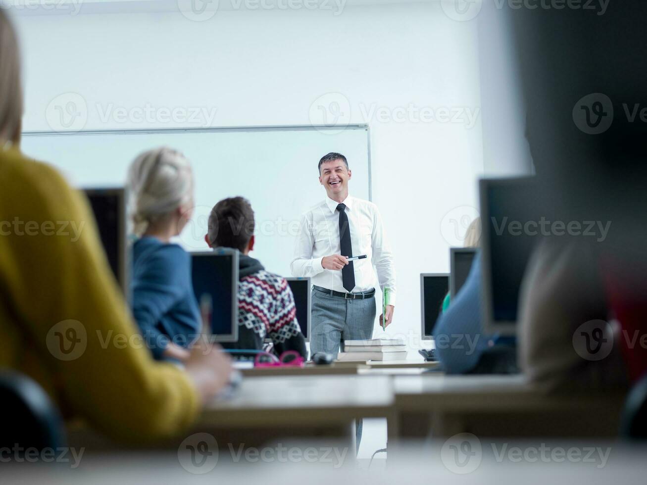 students with teacher  in computer lab classrom photo