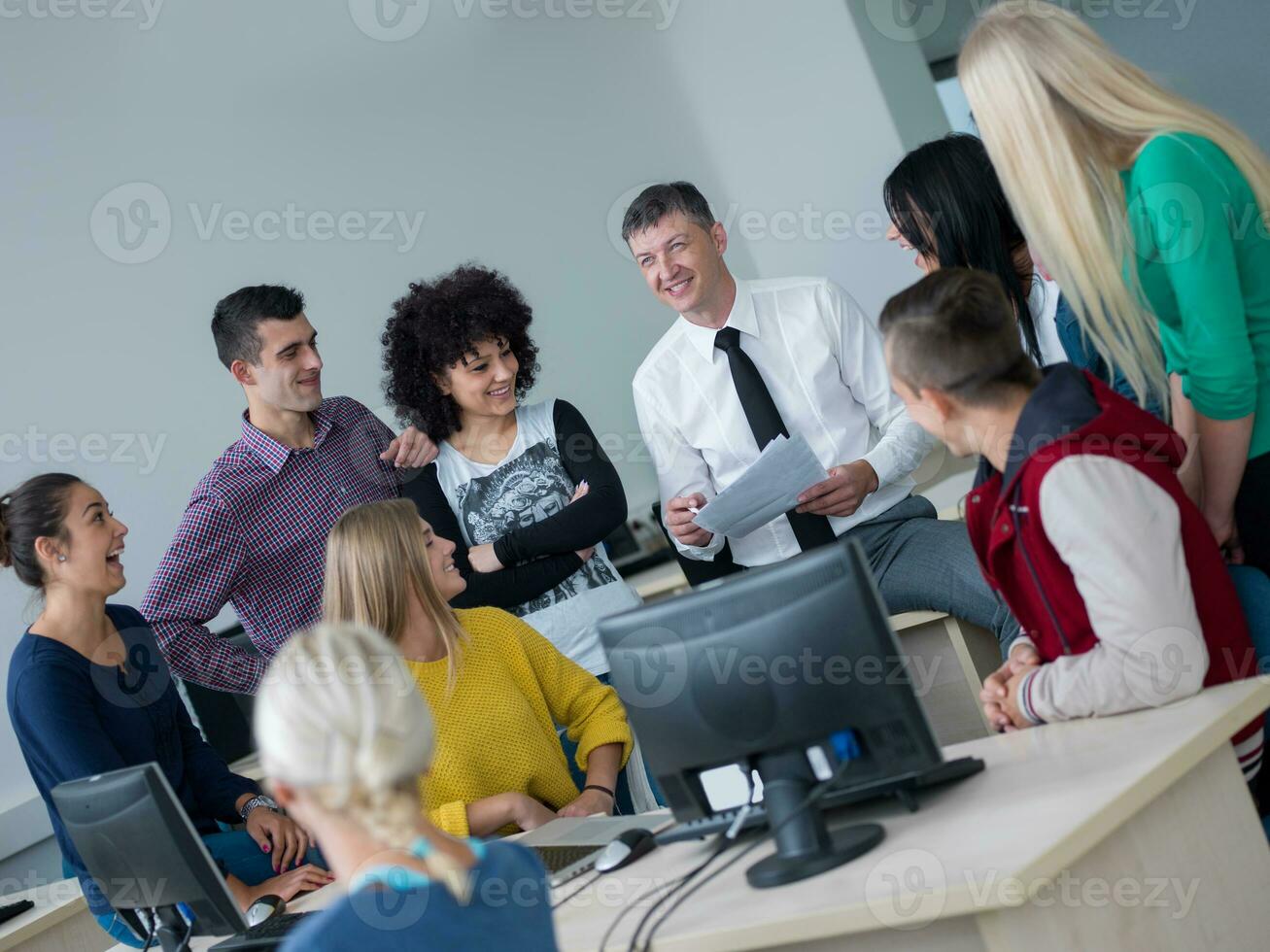 students with teacher  in computer lab classrom photo