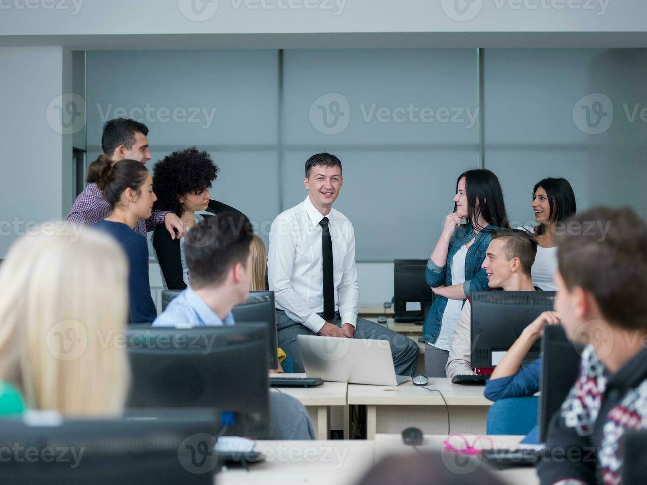 students with teacher  in computer lab classrom photo