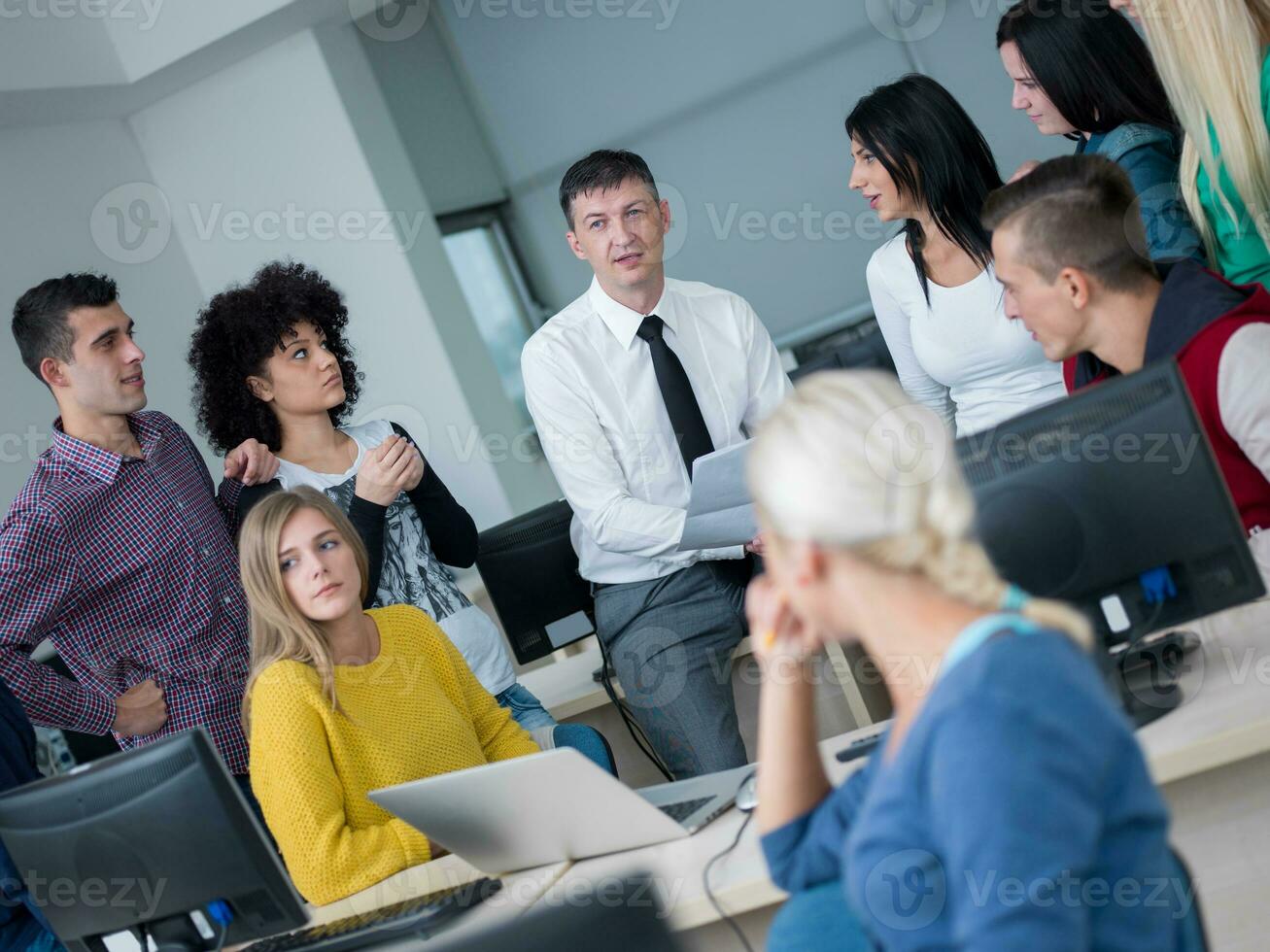 students with teacher  in computer lab classrom photo