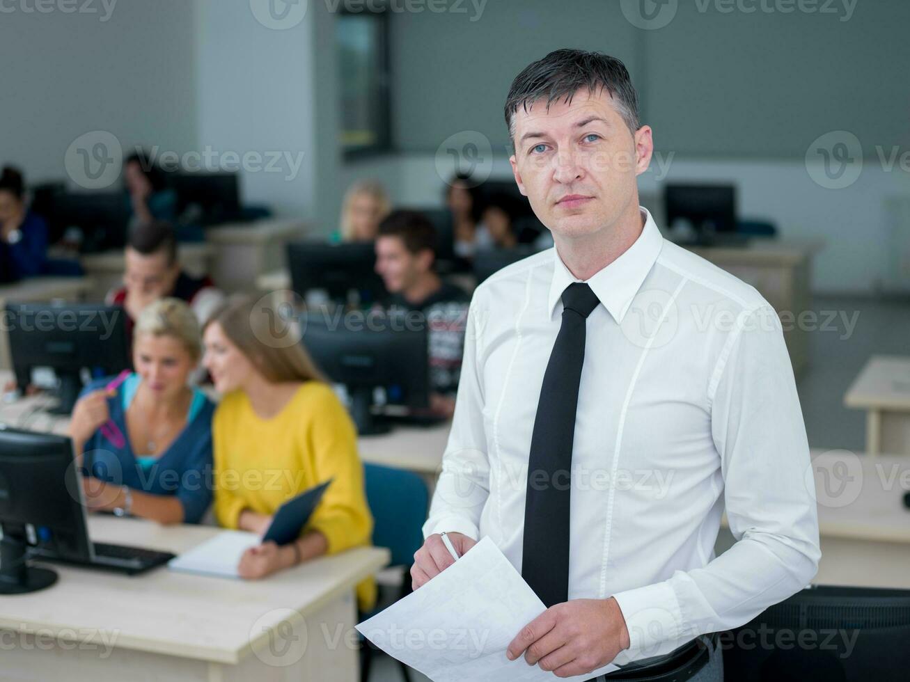 students with teacher  in computer lab classrom photo