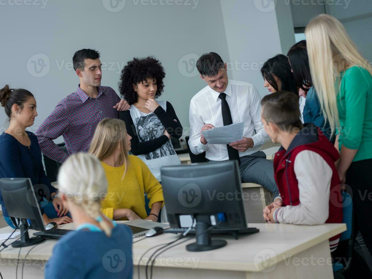 students with teacher  in computer lab classrom photo