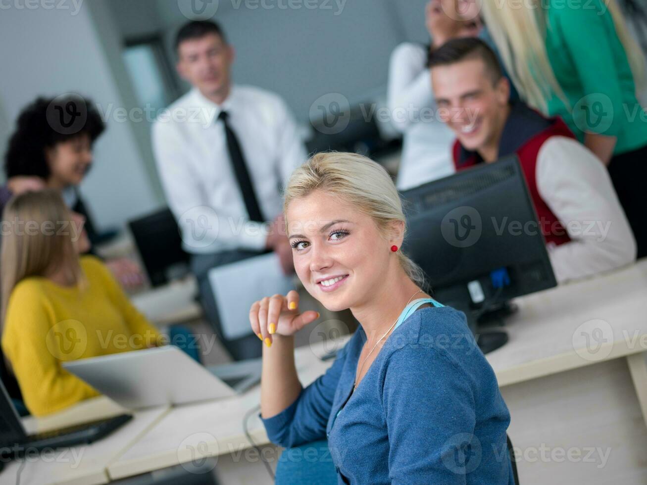 students with teacher  in computer lab classrom photo