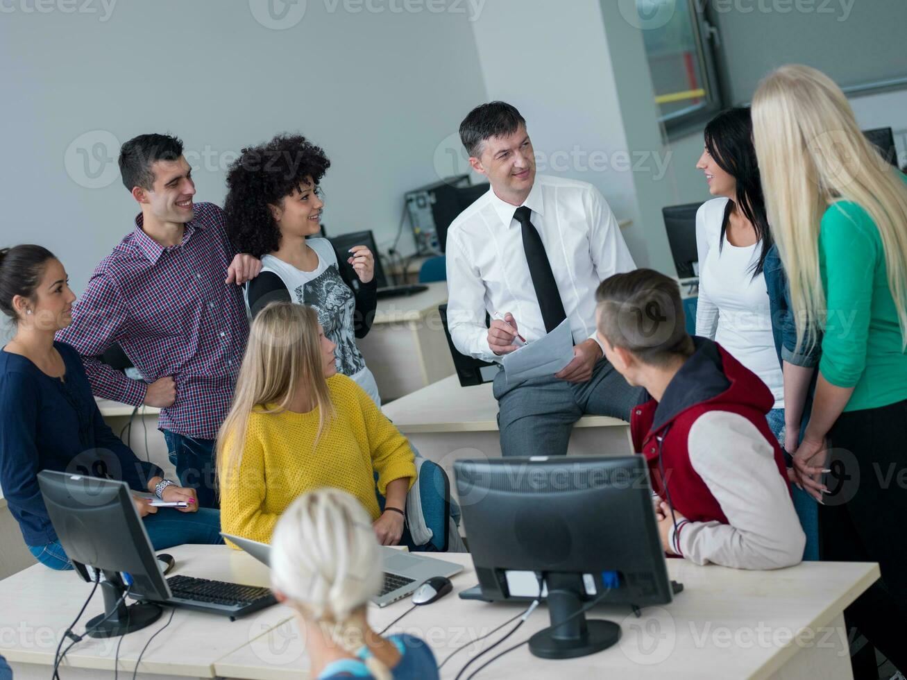 students with teacher  in computer lab classrom photo