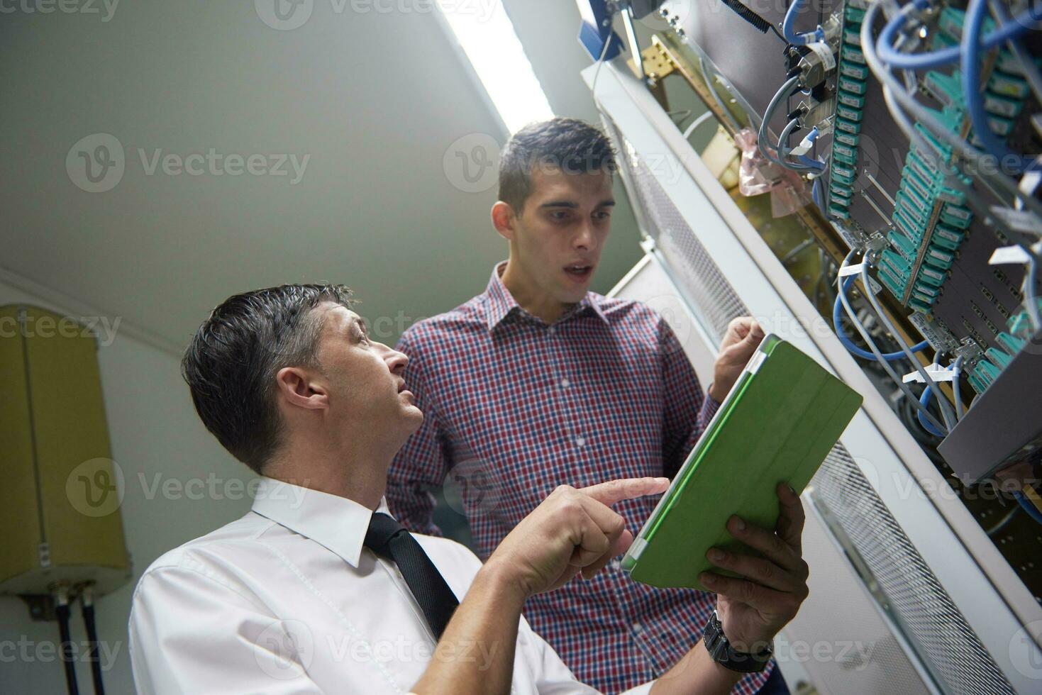 network engineers in server room photo