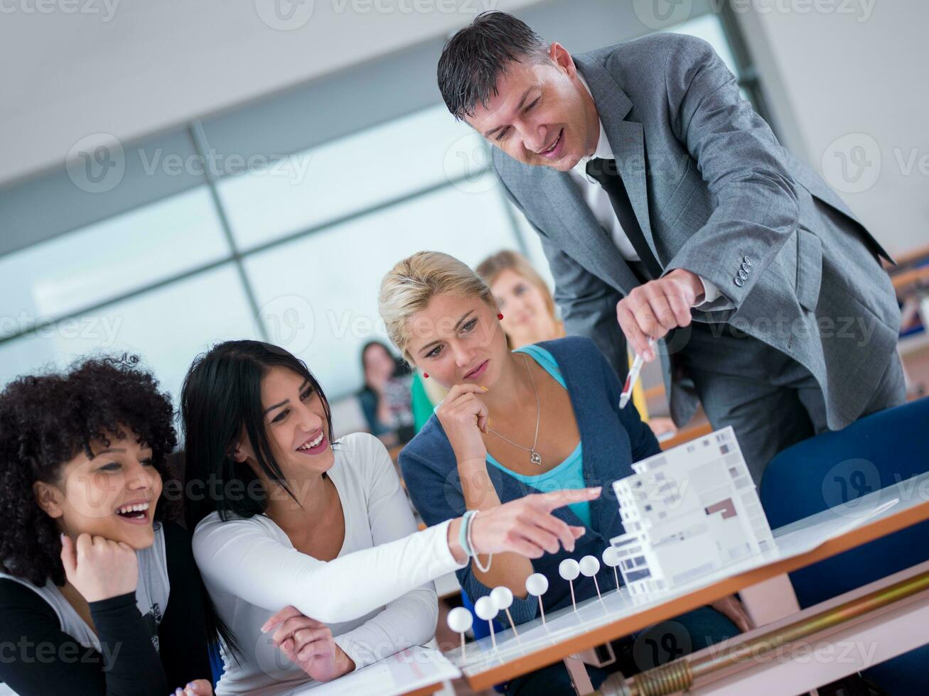 students with teacher  in computer lab classrom photo