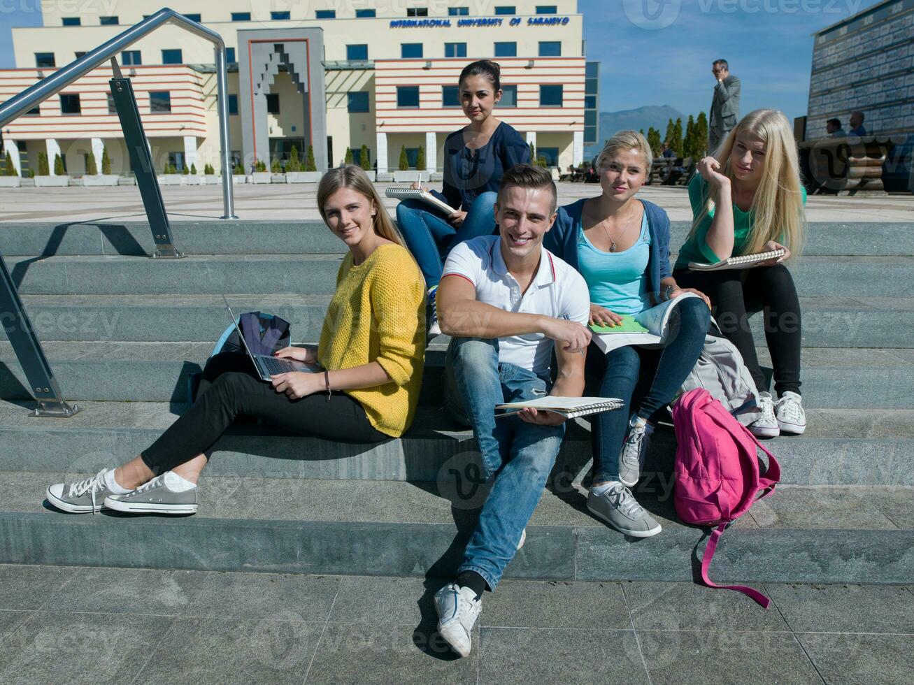 students outside sitting on steps photo