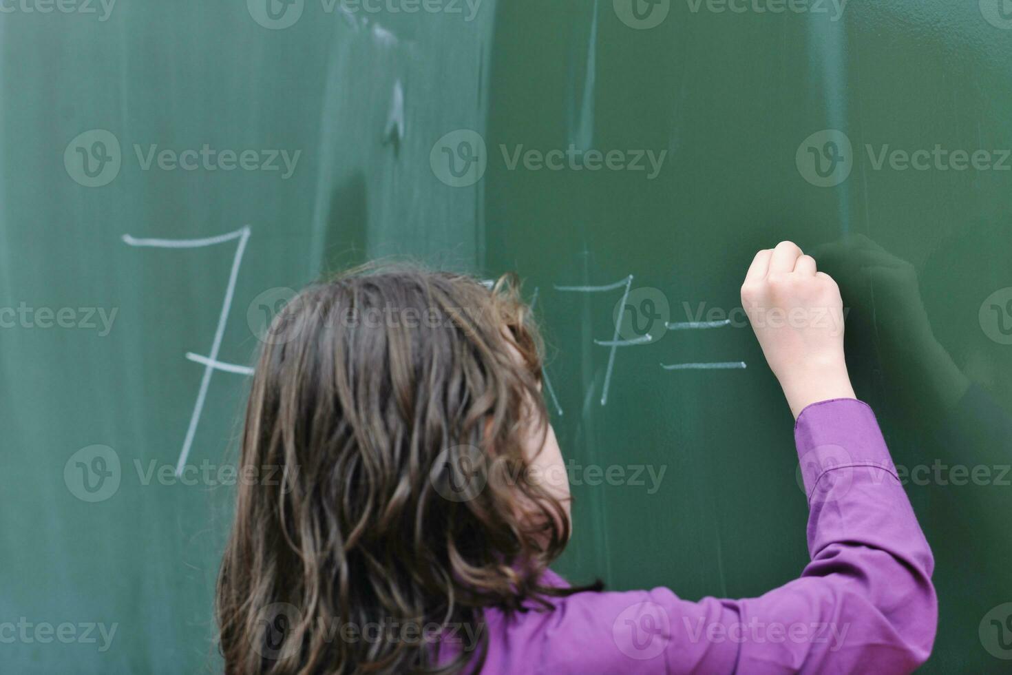 happy school girl on math classes photo