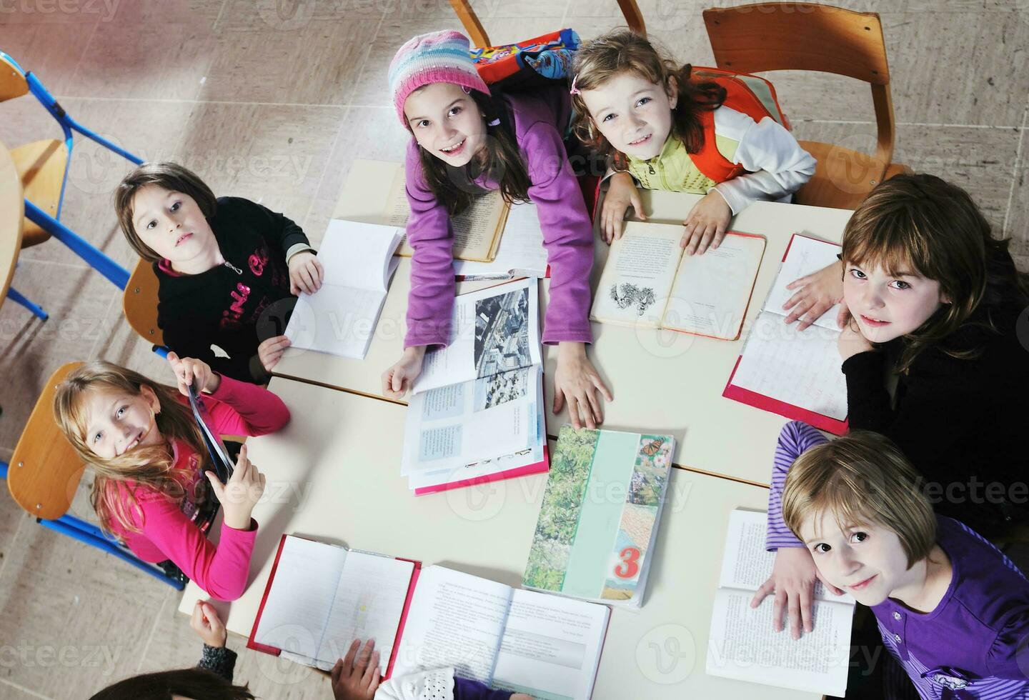 happy kids with  teacher in  school classroom photo