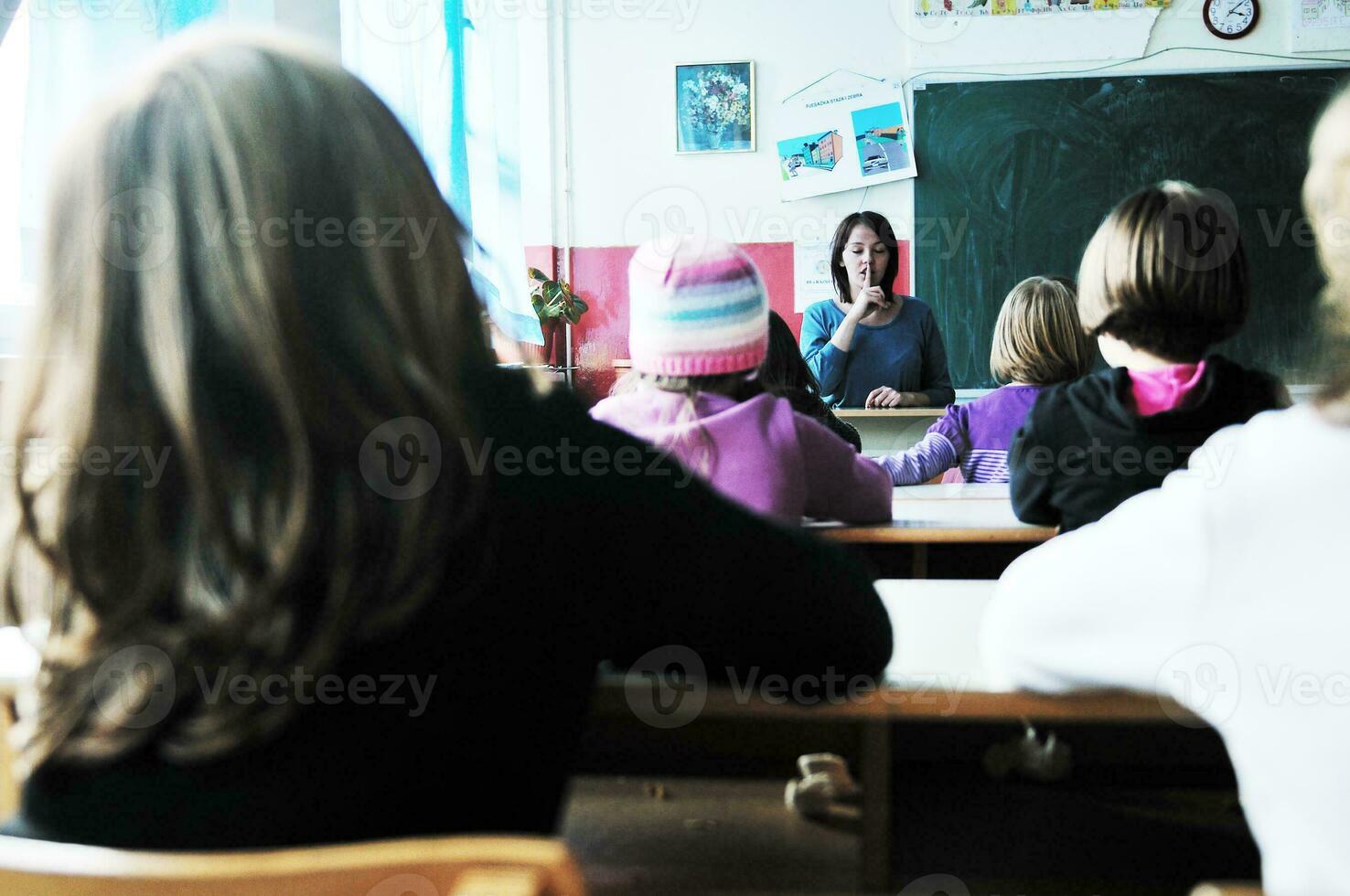 happy kids with  teacher in  school classroom photo