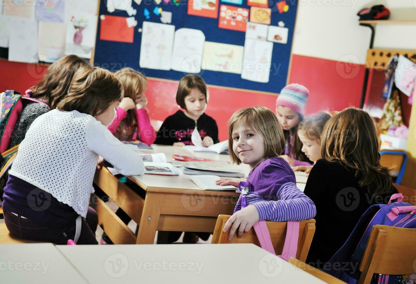 happy kids with  teacher in  school classroom photo