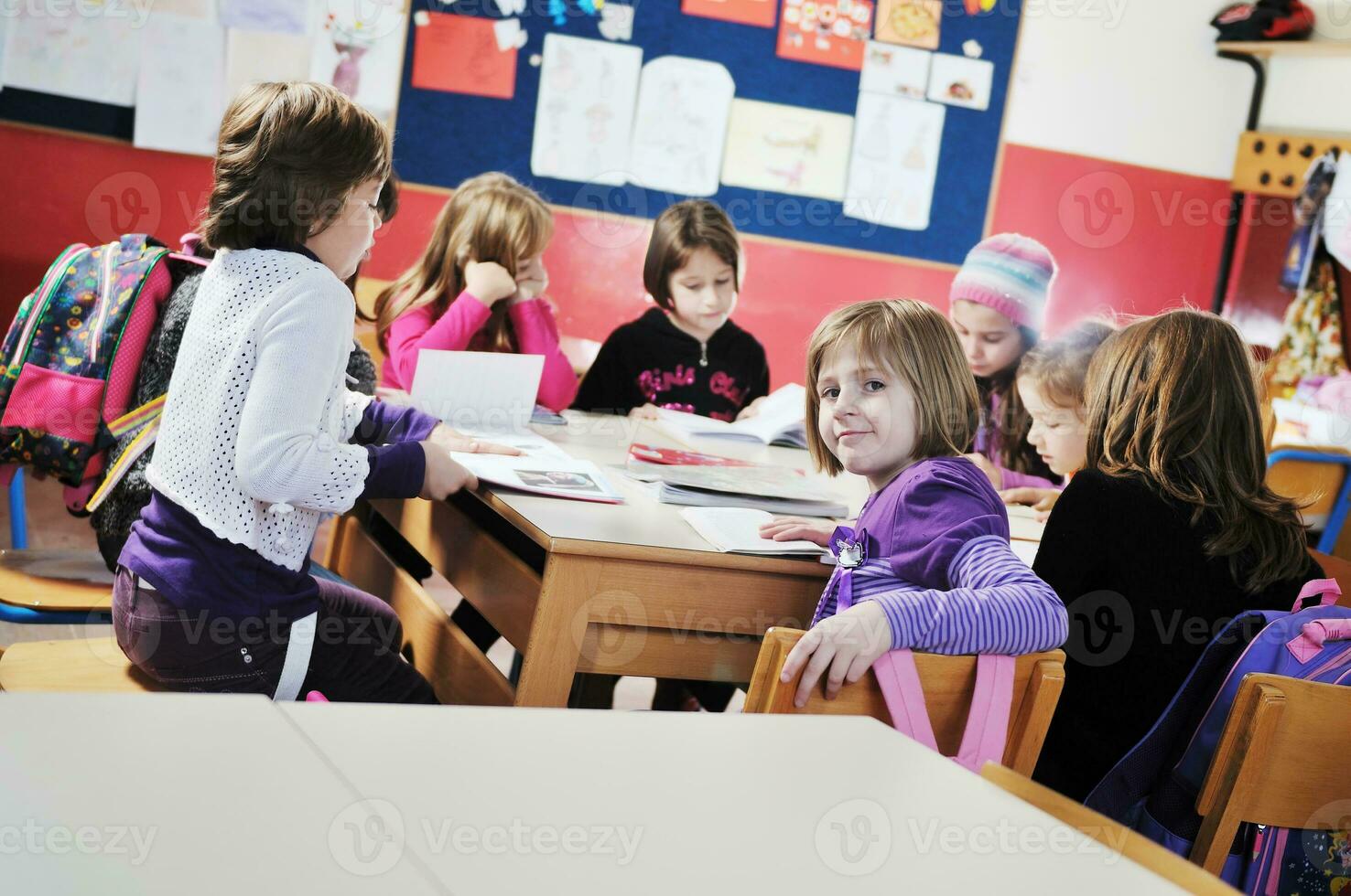 happy kids with  teacher in  school classroom photo