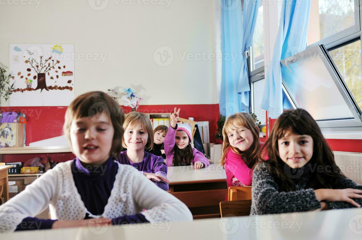 happy kids with  teacher in  school classroom photo