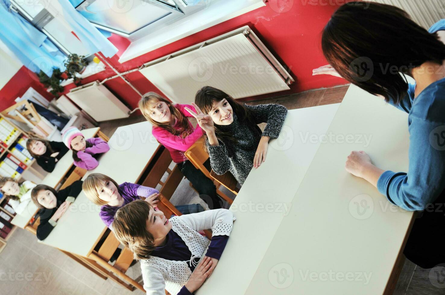 happy kids with  teacher in  school classroom photo