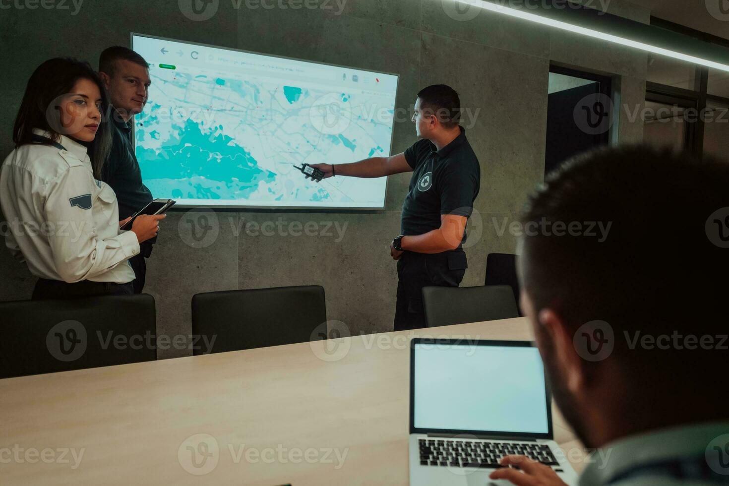 Group of Security data center operators working in a CCTV monitoring room looking on multiple monitors Officers Monitoring Multiple Screens for Suspicious Activities Team working on the System Contr photo