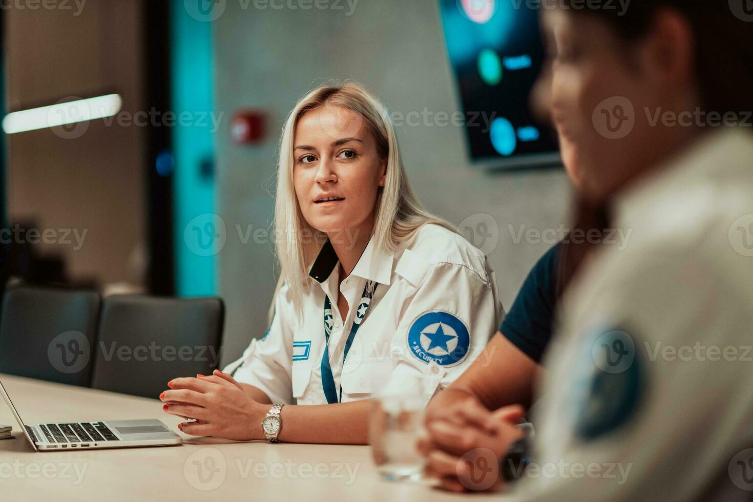 Group of female security operators working in a data system control room Technical Operators Working at workstation with multiple displays, security guards working on multiple monitors in surveillan photo
