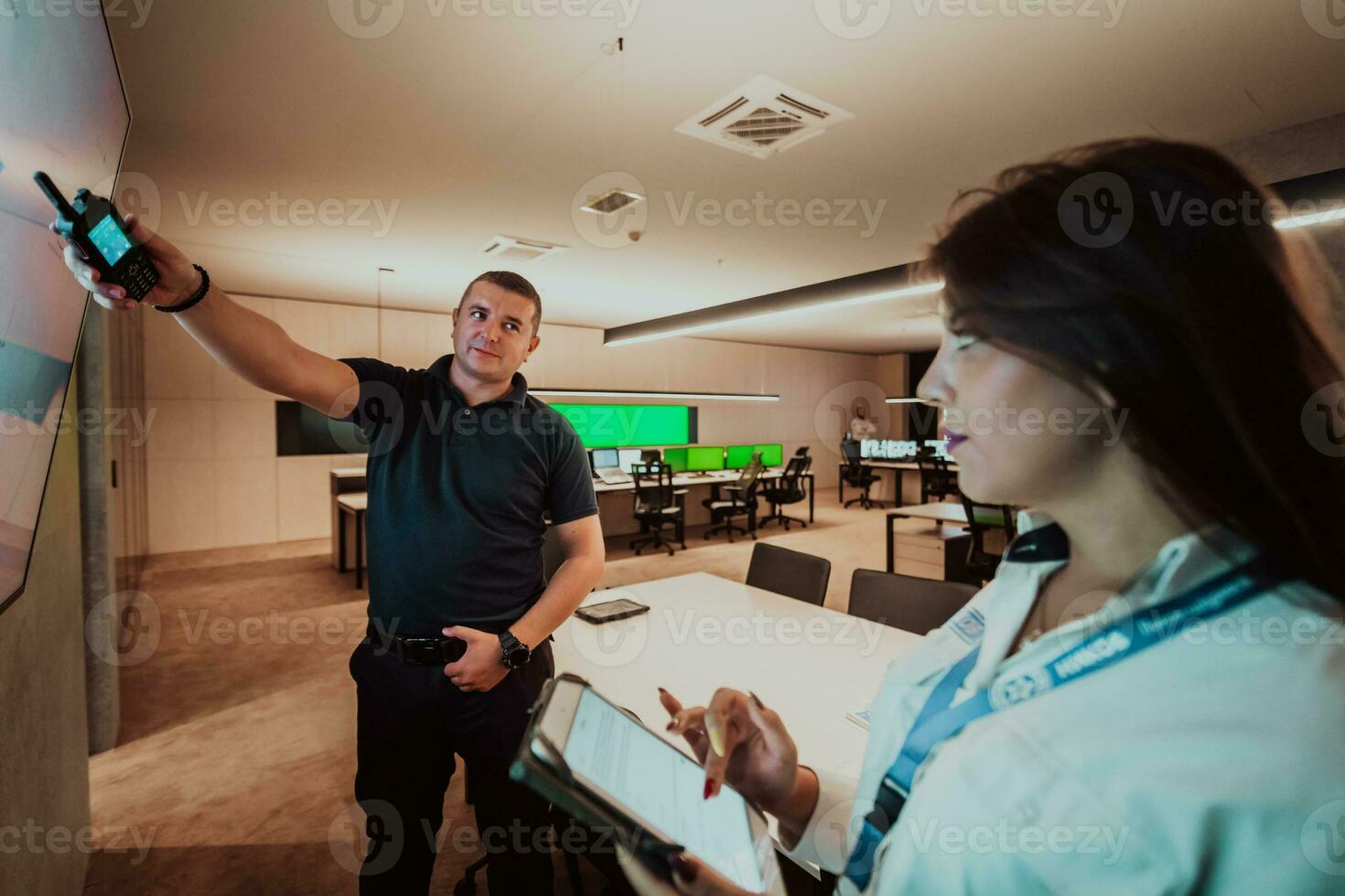 Group of Security data center operators working in a CCTV monitoring room looking on multiple monitors Officers Monitoring Multiple Screens for Suspicious Activities Team working on the System Contr photo