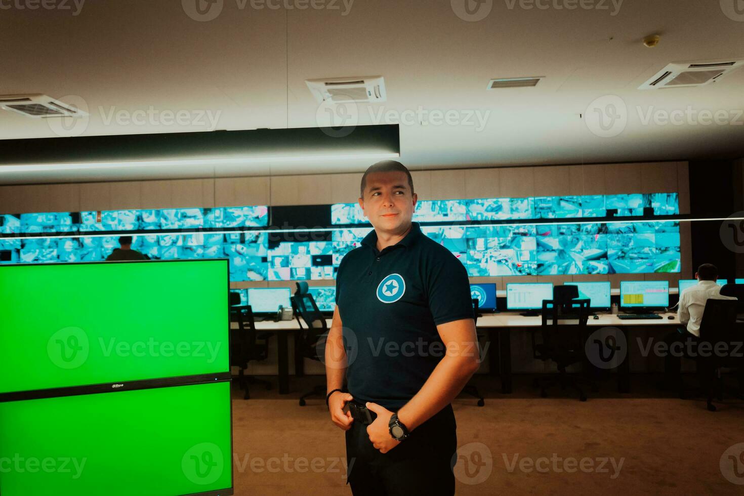 Male security operator working in a data system control room offices Technical Operator Working at workstation with multiple displays, security guard working on multiple monitors Male computer opera photo