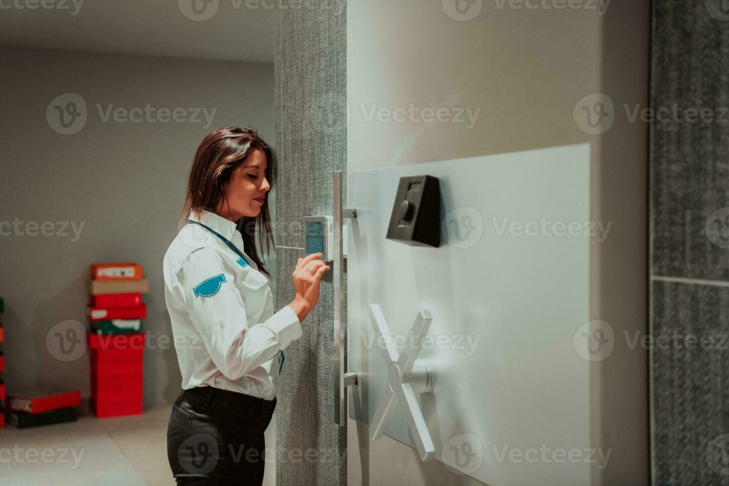 Photo of a woman who works for a bank or a security service opening a safe for money