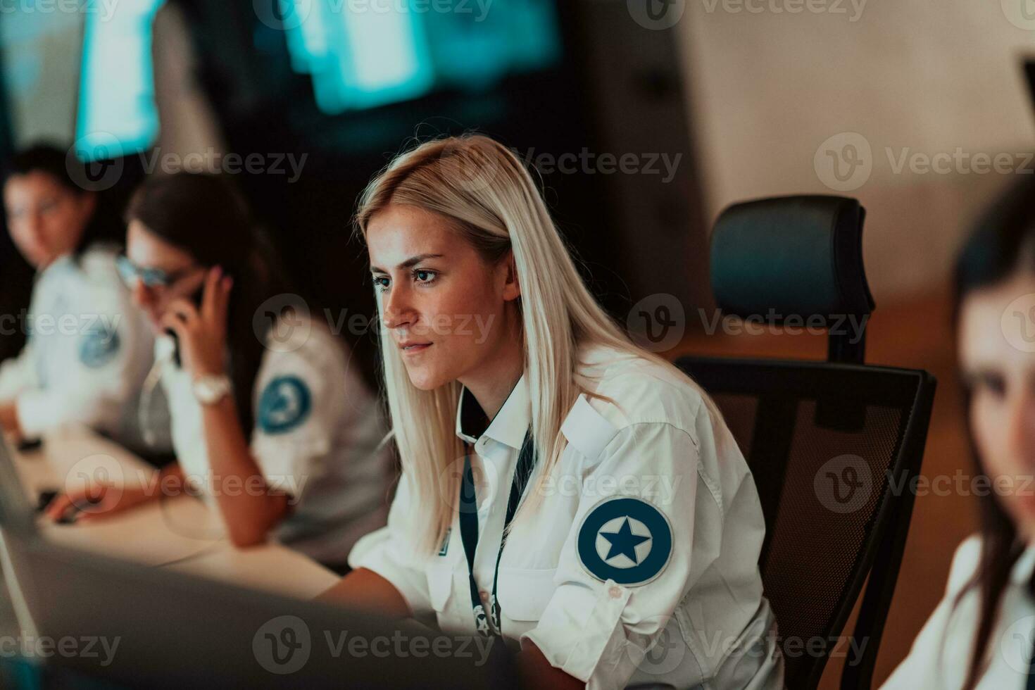 Female security operator working in a data system control room offices Technical Operator Working at workstation with multiple displays, security guard working on multiple monitors photo