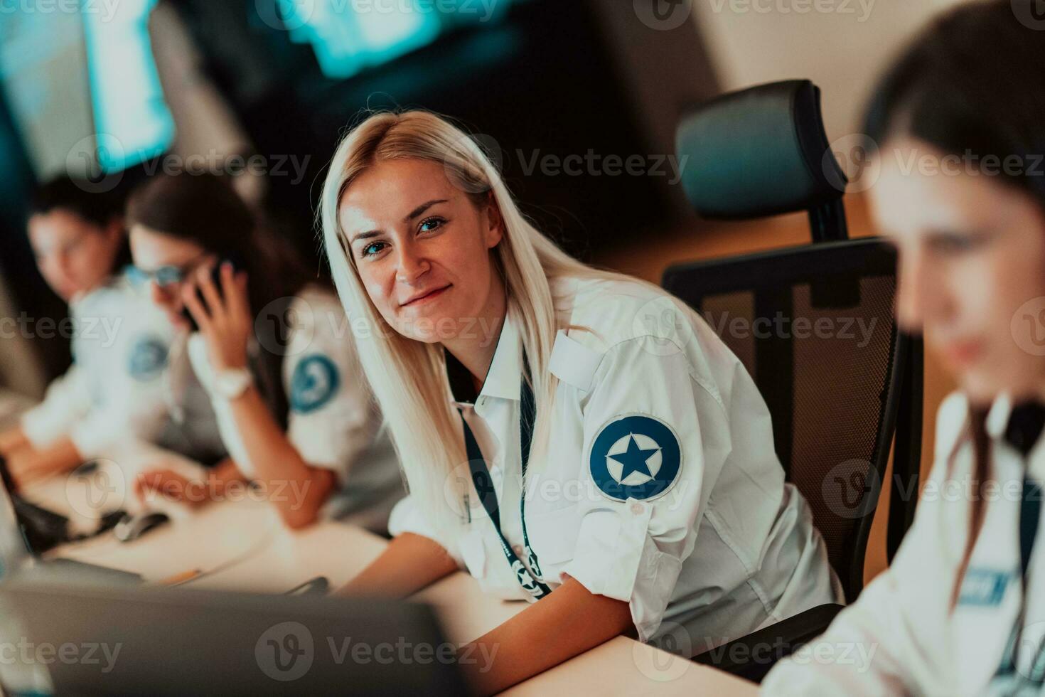 Female security operator working in a data system control room offices Technical Operator Working at workstation with multiple displays, security guard working on multiple monitors photo