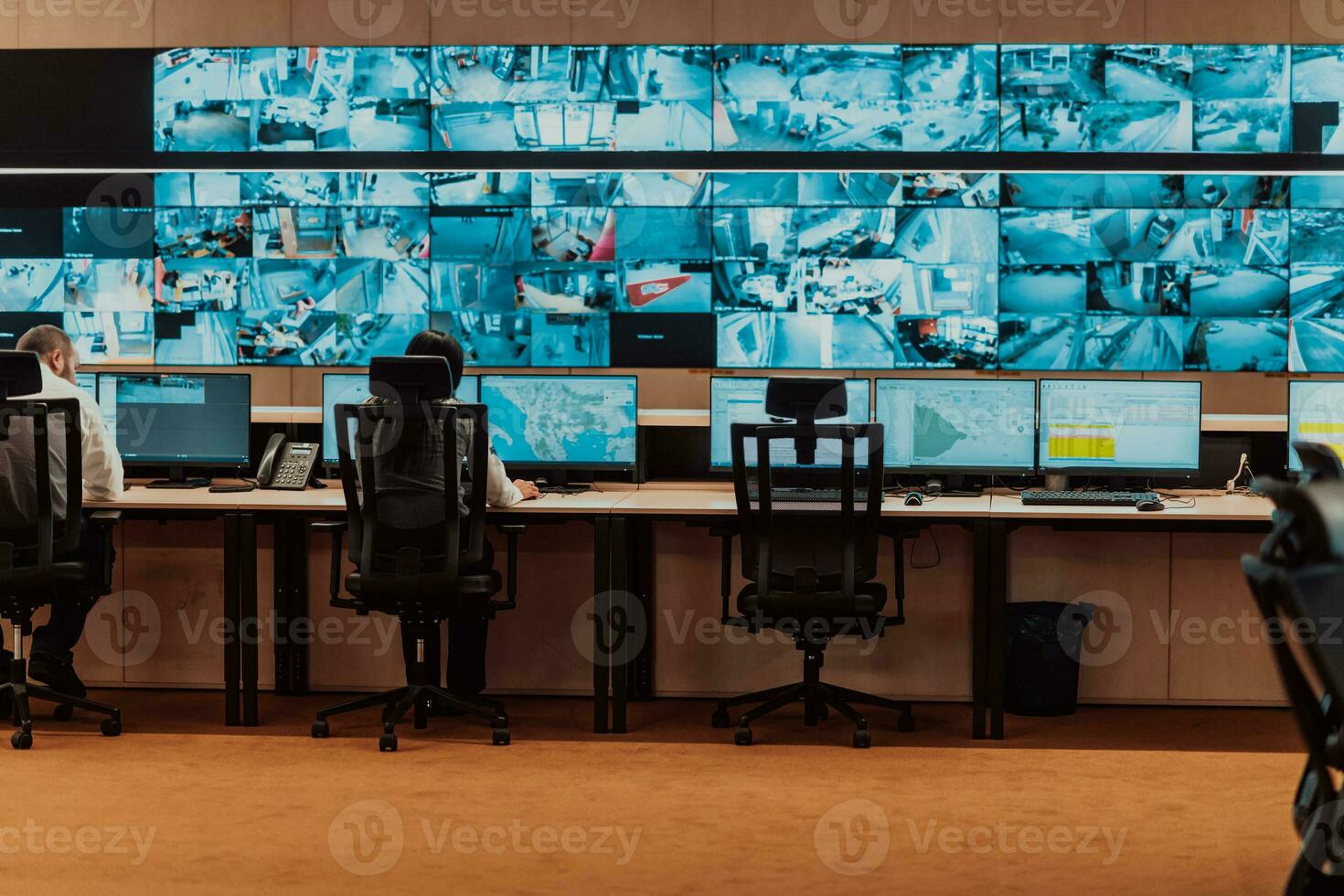 Empty interior of big modern security system control room, workstation with multiple displays, monitoring room with at security data center Empty office, desk, and chairs at a main CCTV security data photo