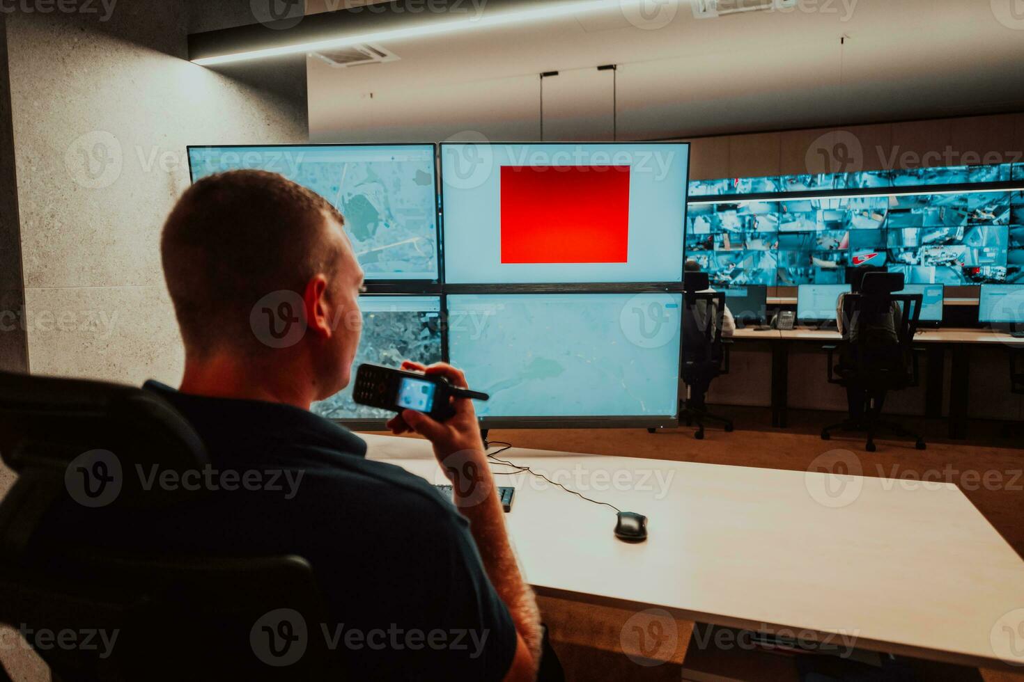 Male security operator working in a data system control room offices Technical Operator Working at workstation with multiple displays, security guard working on multiple monitors Male computer opera photo
