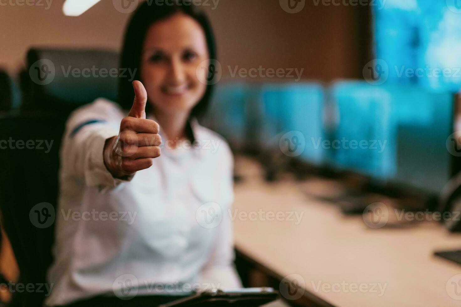 Portrait of female security operator while working in a data system control room offices Technical Operator Working at workstation with multiple displays, security guard working on multiple monitors photo