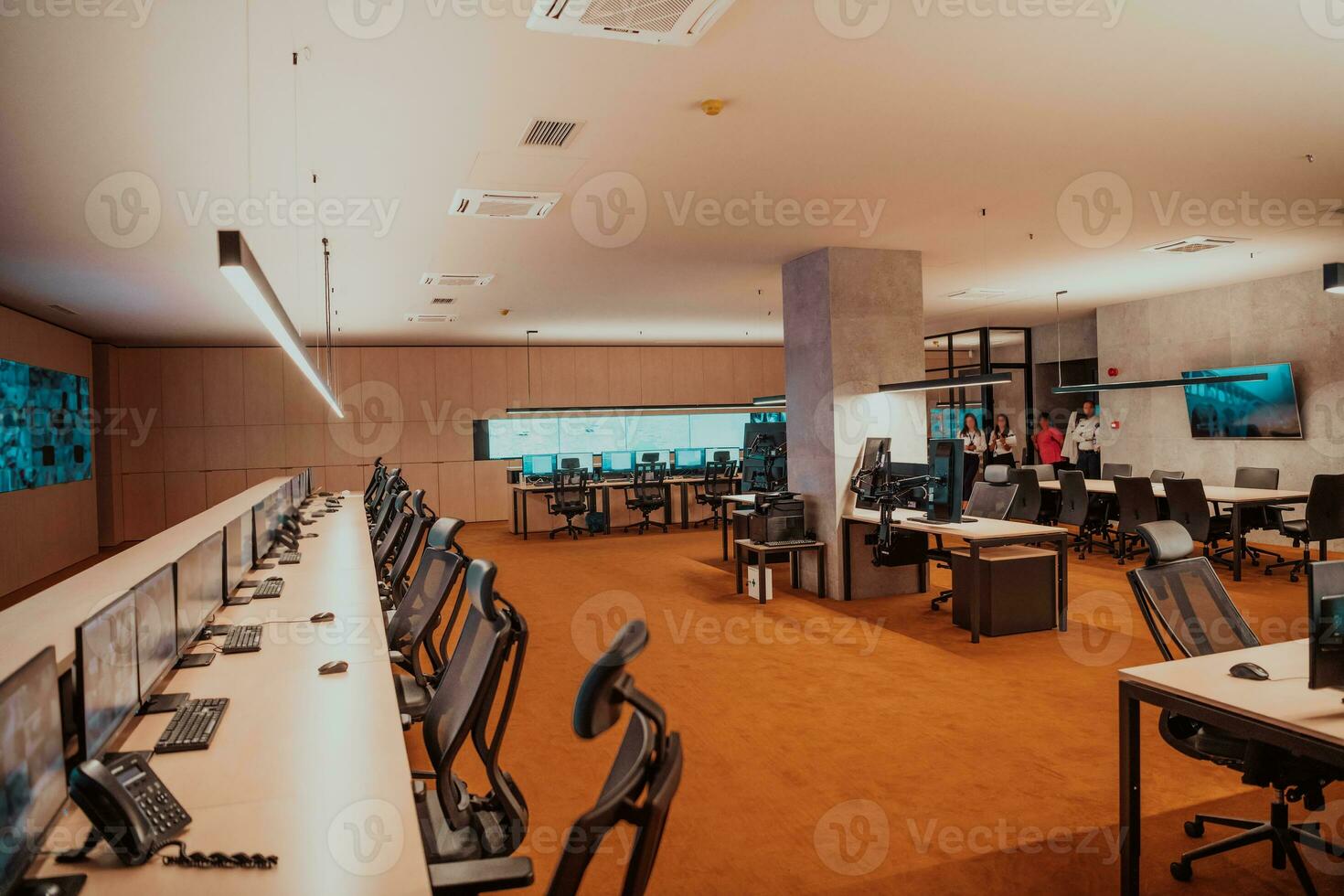 Empty interior of big modern security system control room, workstation with multiple displays, monitoring room with at security data center Empty office, desk, and chairs at a main CCTV security data photo