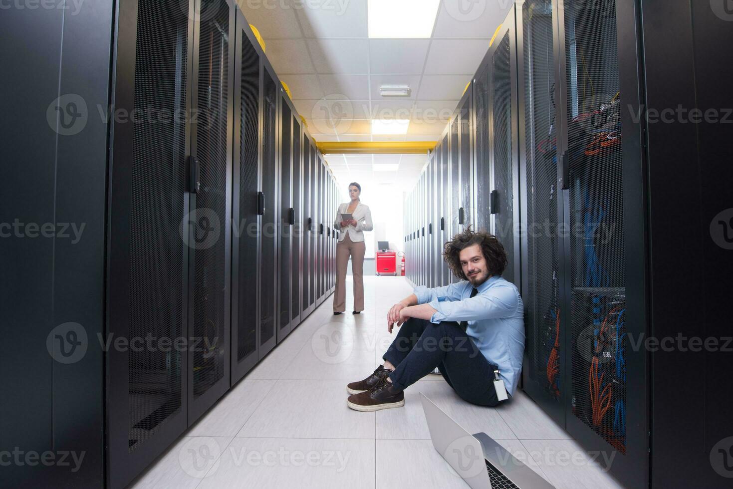 Team of young technicians working together on servers photo