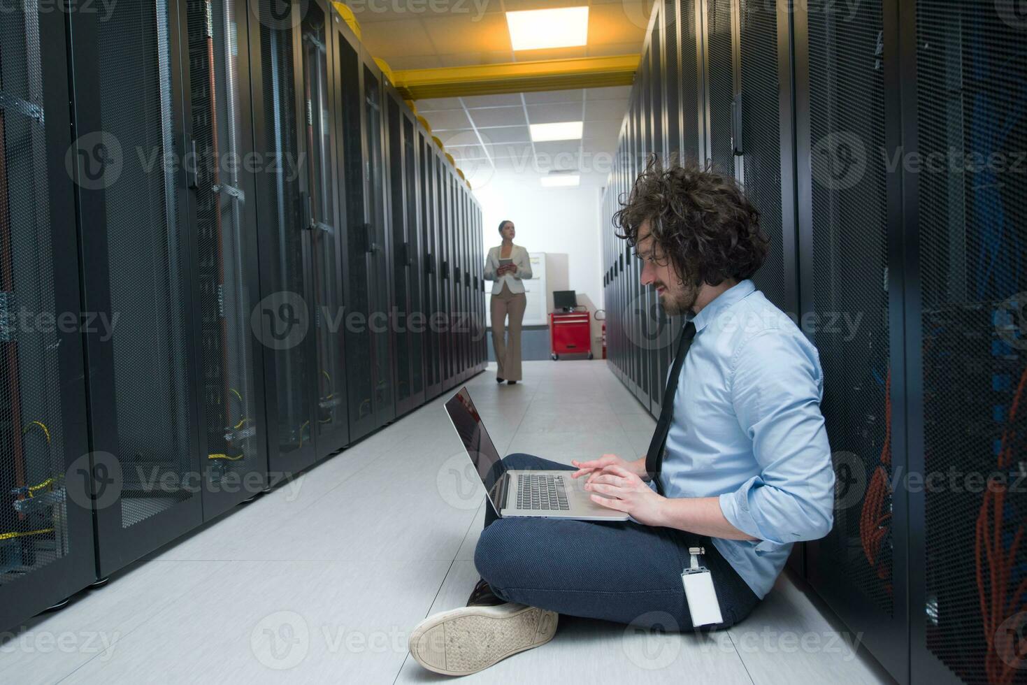 Team of young technicians working together on servers photo