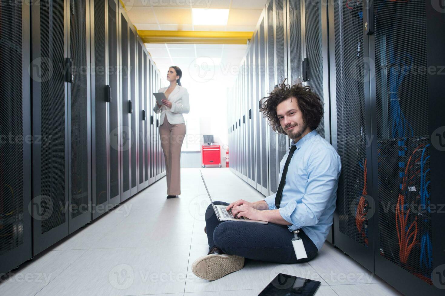 Team of young technicians working together on servers photo