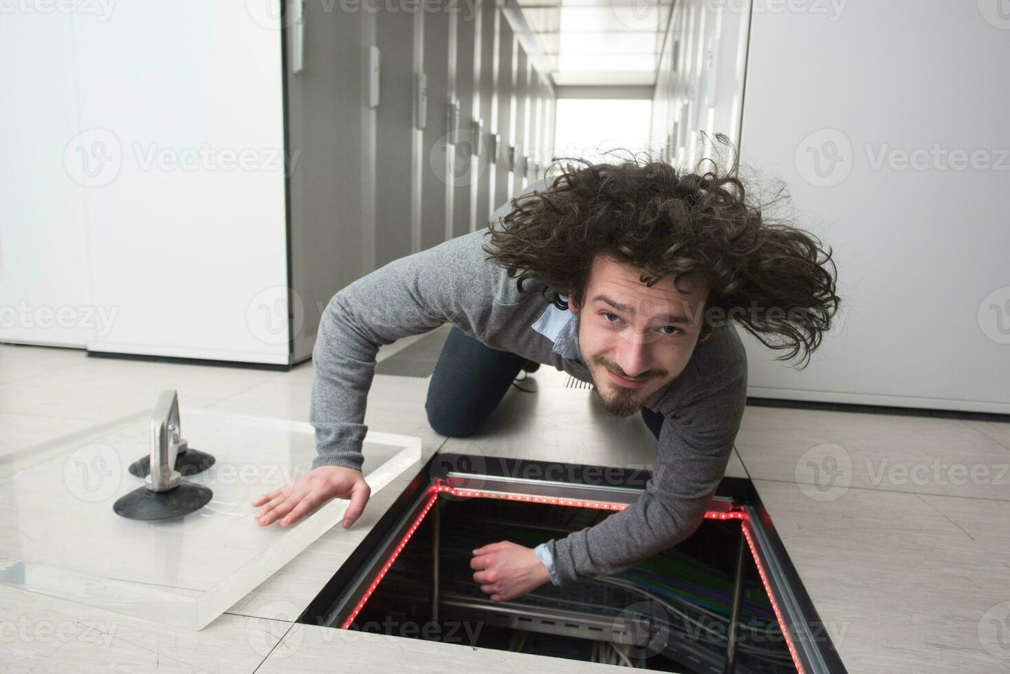 engineer connecting cables in server room photo