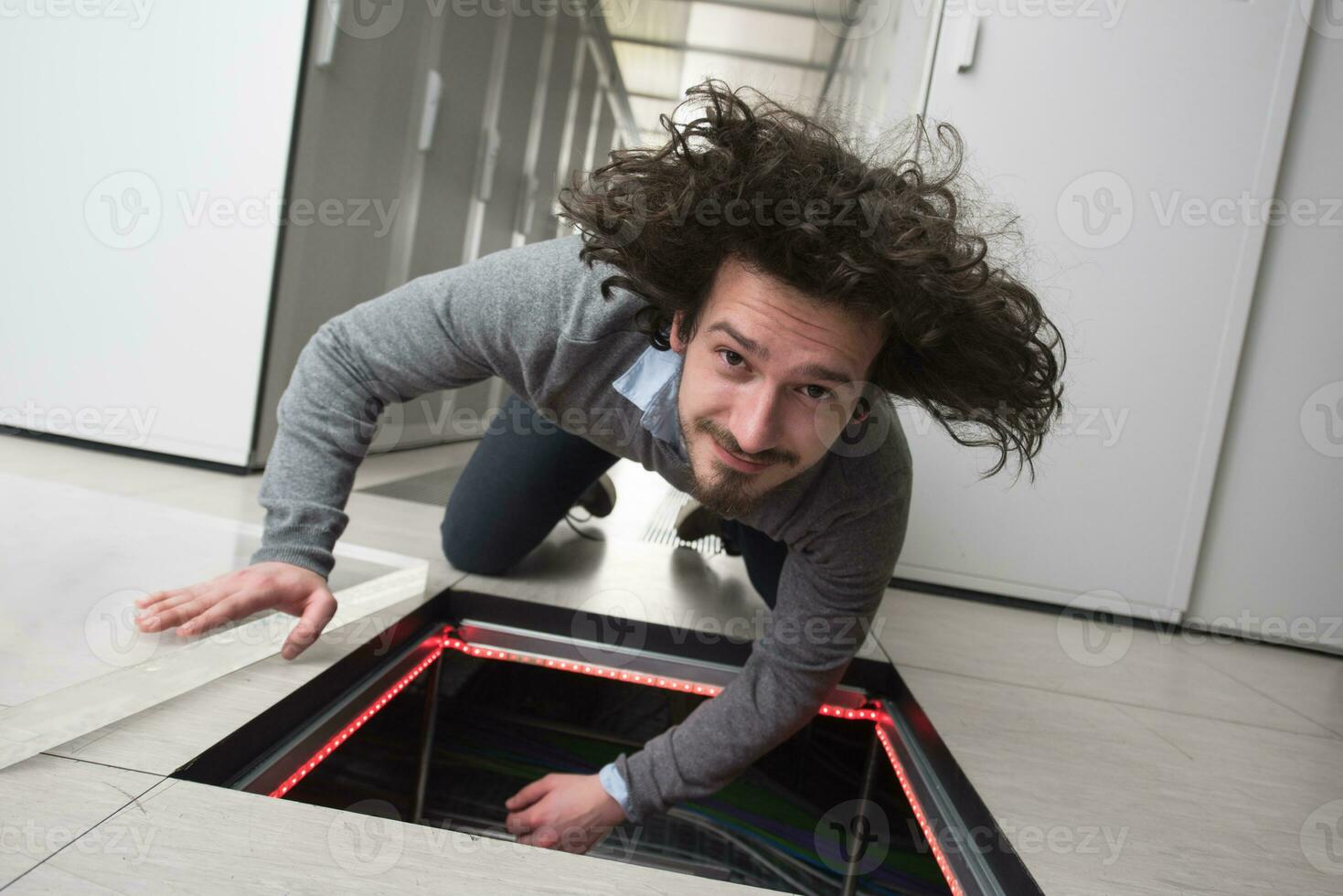 engineer connecting cables in server room photo