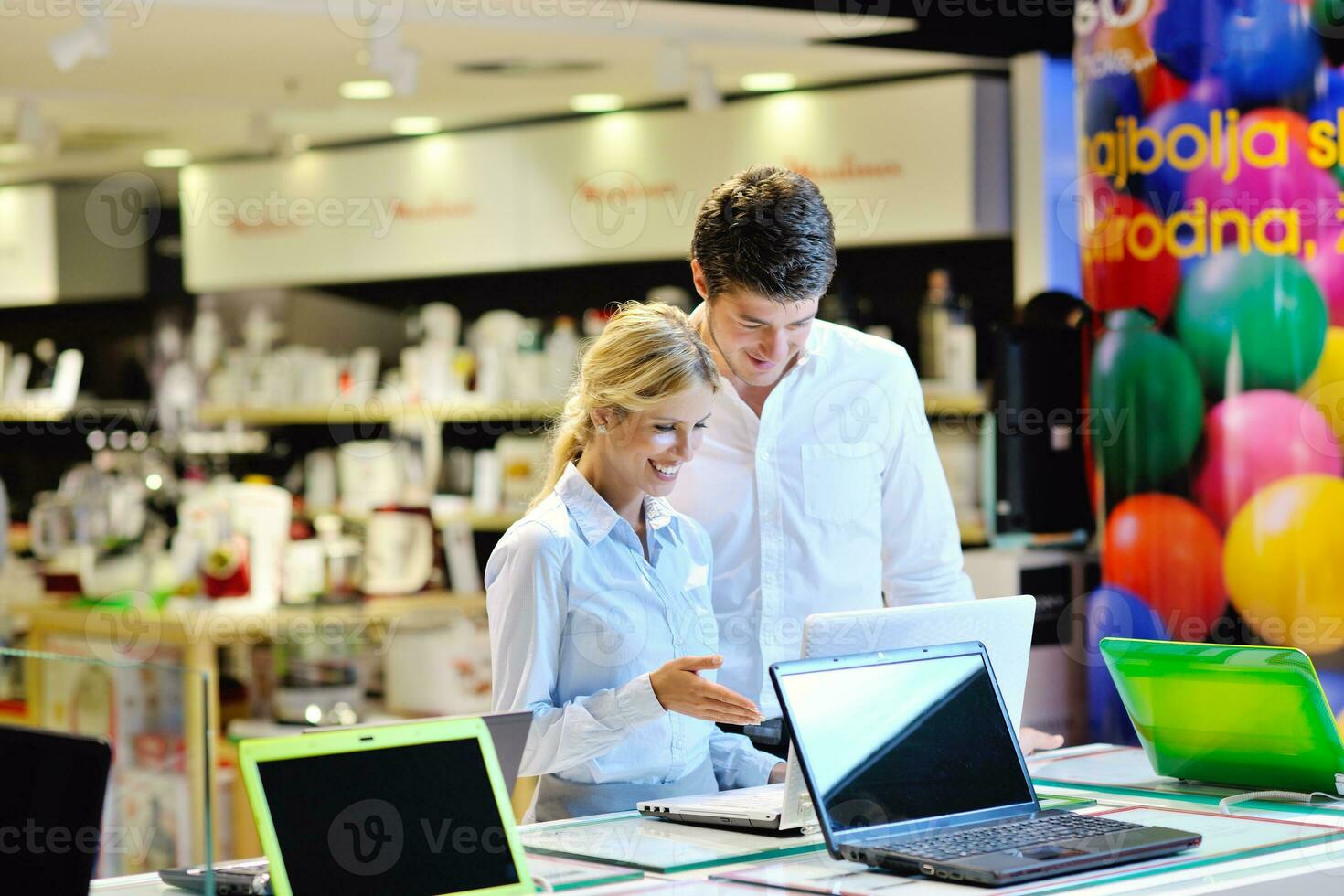 Young couple in consumer electronics store photo