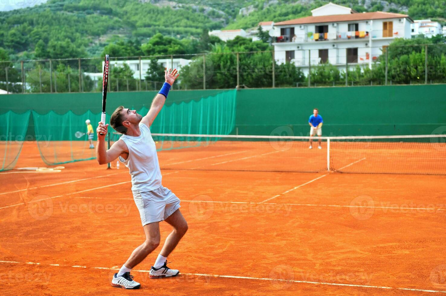 One man play tennis outdoors photo