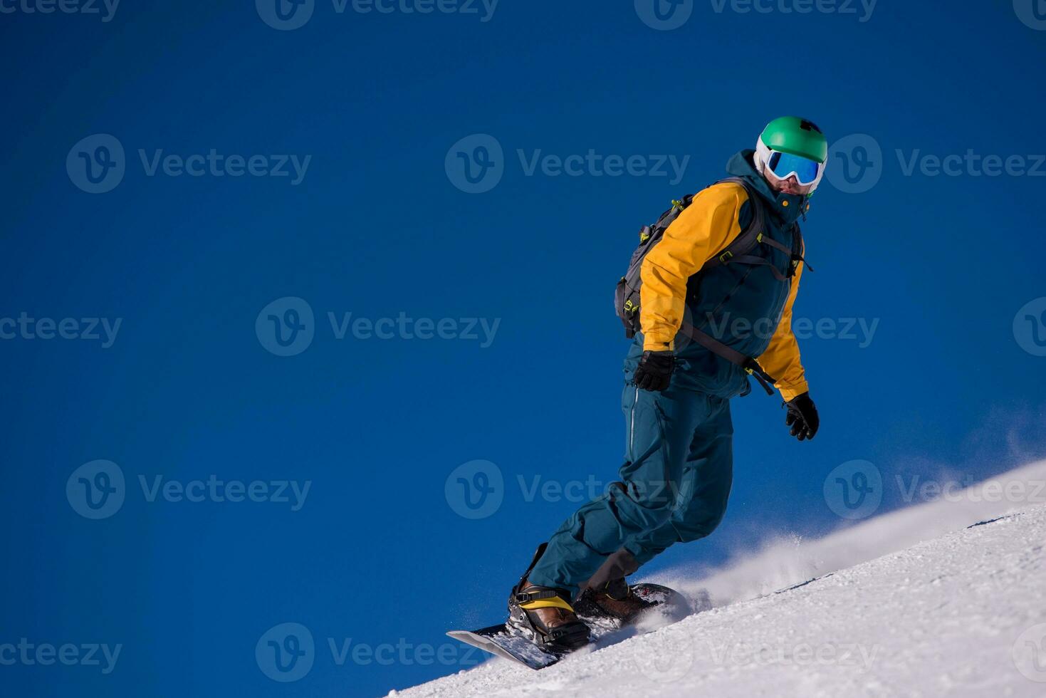 snowboarder running down the slope and ride free style photo